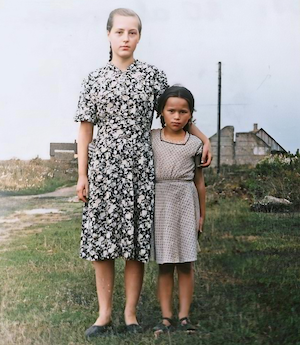 Tirgus Street, also known as Market Street, as there was a market there every Sunday.  The two columns on the right and the wall in the background are the remains of the synagogue of Vishki.  This is Raisa and Julya. Leiser Dumesh called this street Shulgas, Yiddish for Synagogue Street (Shul = synagogue, Gas = Street).